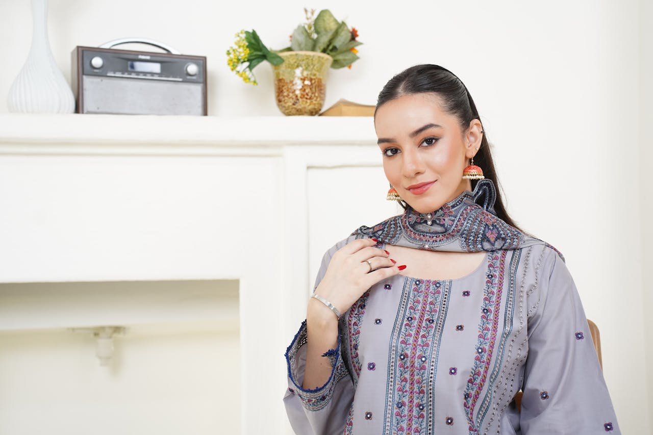 Stylish portrait of a woman in traditional Eastern dress indoors in Lahore.